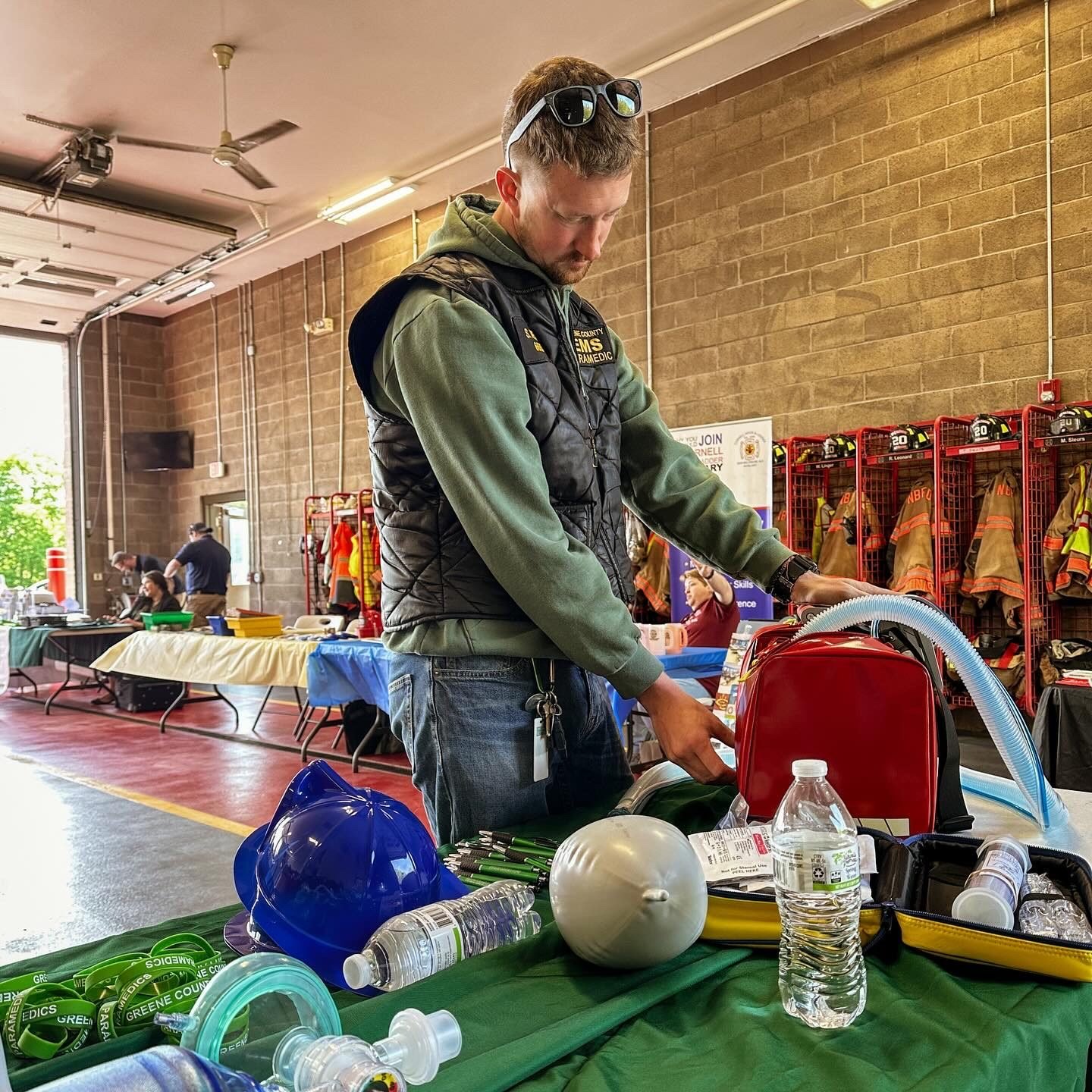 A GCEMS paramedic demonstrating the T1 at a community outreach table
